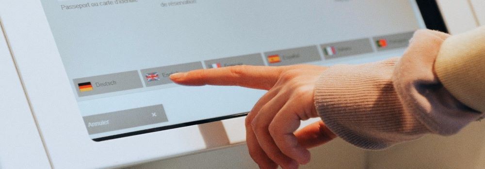 Finger pointing at the tablet kiosk